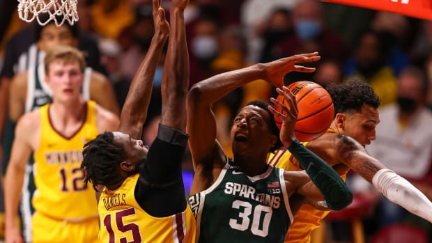 Dec 8, 2021; Minneapolis, Minnesota, USA; Minnesota Gophers guard Payton Willis (0) fouls Michigan State Spartans forward Marcus Bingham Jr. (30) as he drives to the basket during the second half at Williams Arena. Mandatory Credit: Harrison Barden-USA TODAY Sports